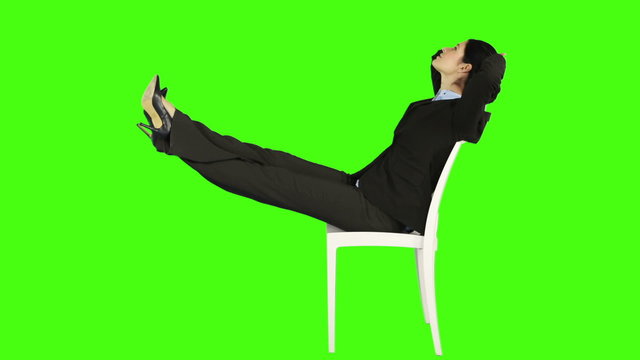 Business woman relaxing on a chair with legs up