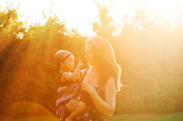 Mother and lovely daughter at sunny park