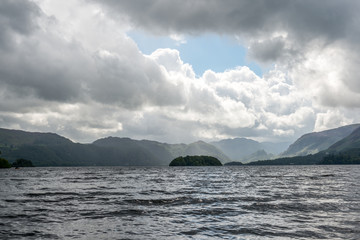 Mountain and clouds over large lake
