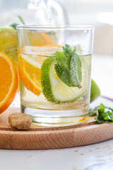 Lemonade and ingredients on white wood background