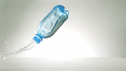 Plastic bottle falling and spilling - Powered by Adobe