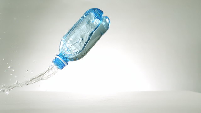 Plastic bottle falling and spilling - Powered by Adobe