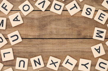 A border of various tan letter tiles