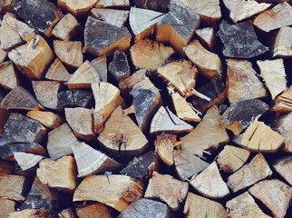 Stack of chopped firewood. Horizontal background cool toned
