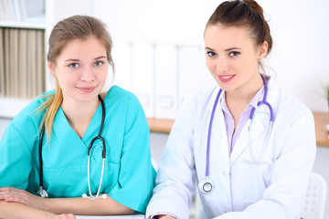 Female doctor  and young surgeon intern in hospital