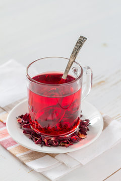 Karkade tea on white wood background