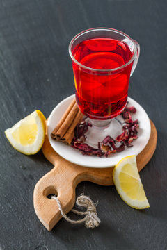 Karkade tea on dark stone background