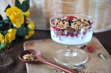 Granola with Yogurt Glass on Wooden Board