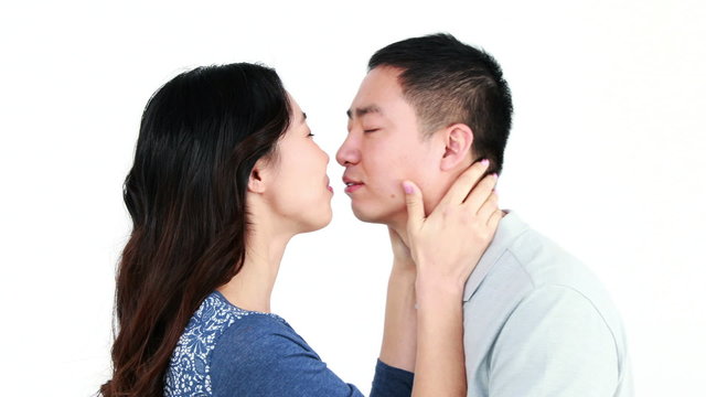 Happy Asian couple kissing and smiling