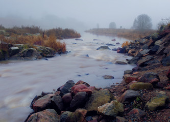 Granite stones and fog on Yenisei River bank near Divnogorsk, Russia
