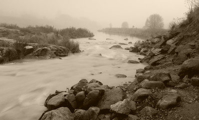 Granite stones and fog on Yenisei River bank near Divnogorsk, Russia