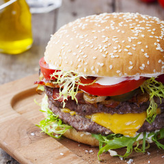 Burger, hamburger with frech fries, ketchup, mustard and fresh vegetables
