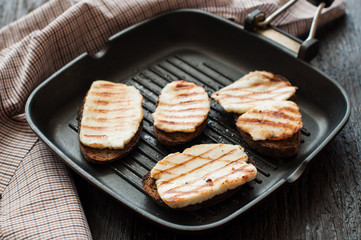 Crostini with fried cheese on the grill