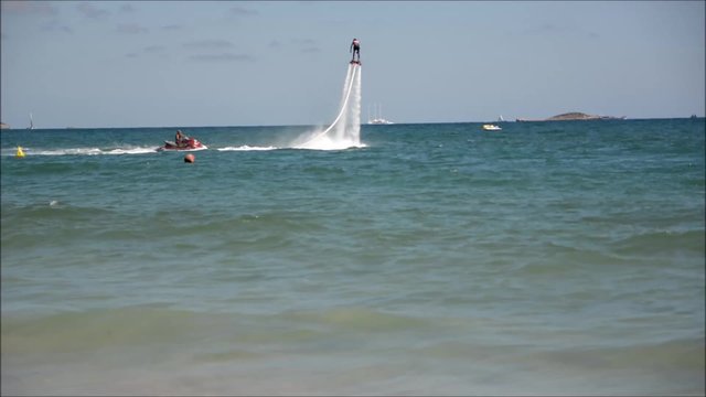 Man doing flyboarding with his flyboard in European beach