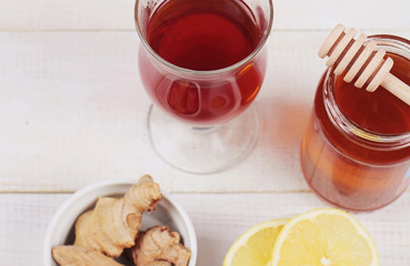 Hot tea lemon ginger honey on white wooden background. Warmth concept. Hot Winter drink, New year and Christmas time