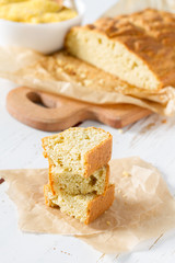 Corn bread cut in peaces on white wood background