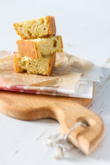 Corn bread cut in peaces on white wood background
