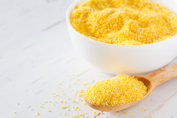 Dry corn on white wood background