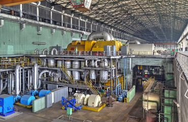 Machine room in thermal power plant with electric generators and turbines