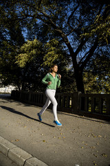 Fototapeta premium Young woman running in the park