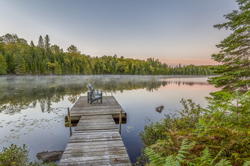 Dock and Chairs on a Lake at Sunset