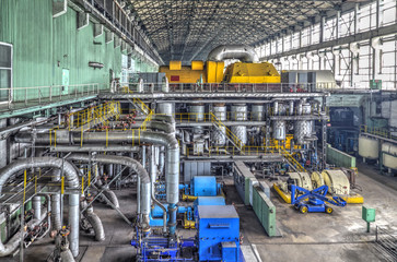 Machine room in thermal power plant with electric generators and turbines