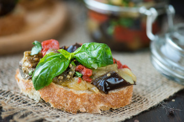 Toast with baked eggplant with tomatoes, garlic