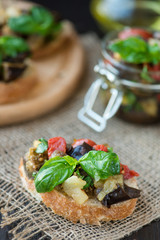 Toast with baked eggplant with tomatoes, garlic