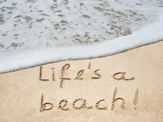 Fototapeta premium Conceptual life is a beach text in sand and water