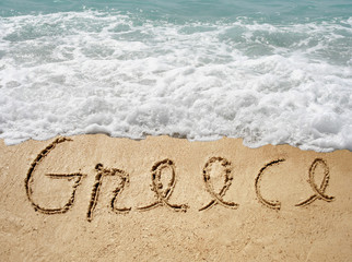 Conceptual Greece text in sand and water