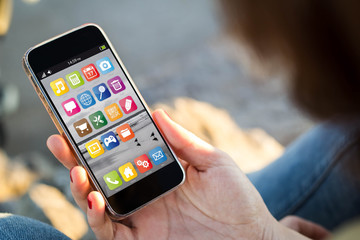 woman sitting in the street holding her smartphone