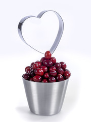 A bowl with cranberries and the silhouette of a heart
