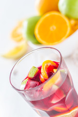 Sangria and ingredients on white wood background