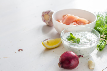 Souvlaki and ingredients, white wood background