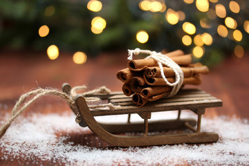 Christmas composition with sledge and cinnamon sticks.Winter.Abstract light background.Selective...