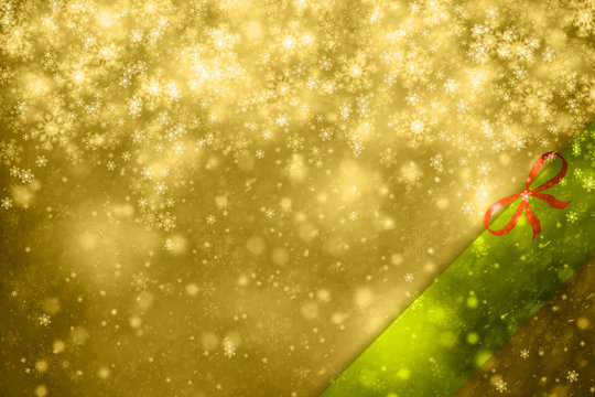 Gold colored abstract Christmas and New Year snowy greeting card with green colored copy space background and with red ribbon. Conceptual winter holiday greeting card illustration.