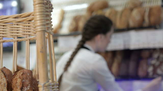 Girl baker put price labels on bread