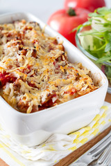 Lasagna served in white bowl with salad