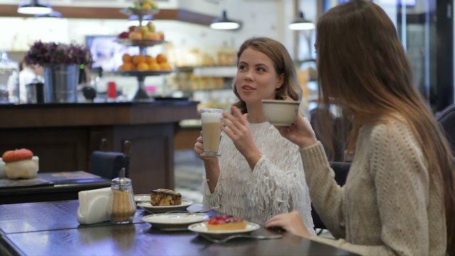Girls having fun talking in coffee shop