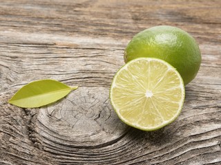 Fresh limes on wooden background