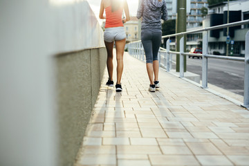 Women jogging in city in dusk