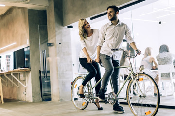 Business people on twin bicycle