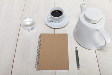 Schreibtisch Draufsicht mit Notizheft und Bleistift, sowie Kaffe