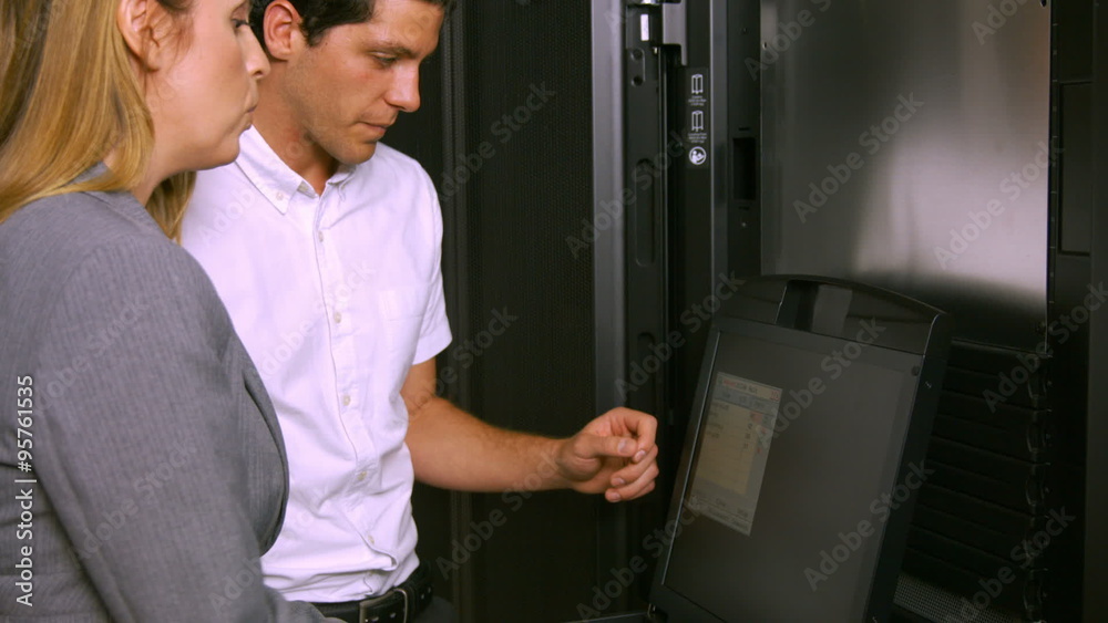 Poster Technicians using laptop in server room