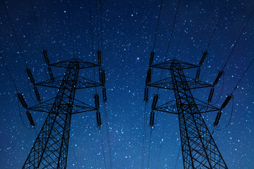 High voltage pylons on a starry night