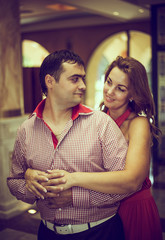 enamored couple posing in a hall