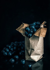 Dark blue grape on the black background