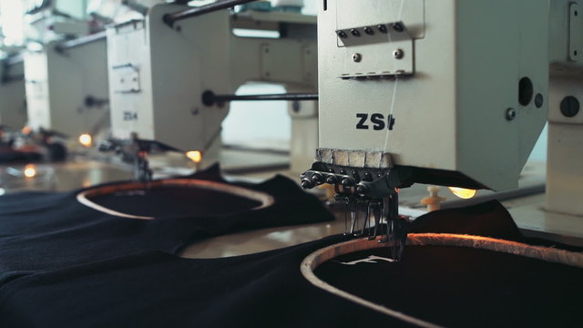 professional equipment on a garment factory in working process slow motion