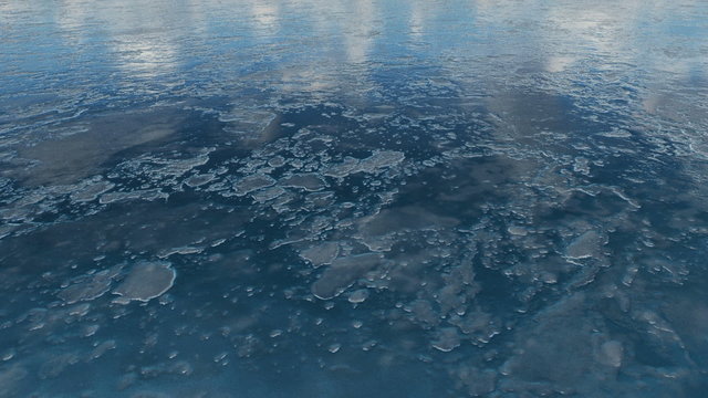 Natural winter background. Camera moves above the dark blue icy surface of a frozen lake. Realistic 3D animation.