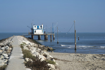Adriatic, Italy. Stilt house by the sea and fishing nets